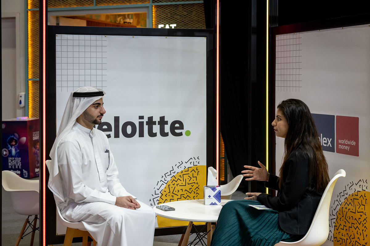 Emirati man explaining school kids on future jobs