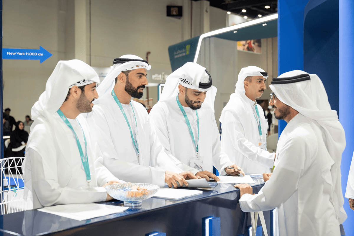 Exhibitor helping visitor to navigate a stall at ruyaa career