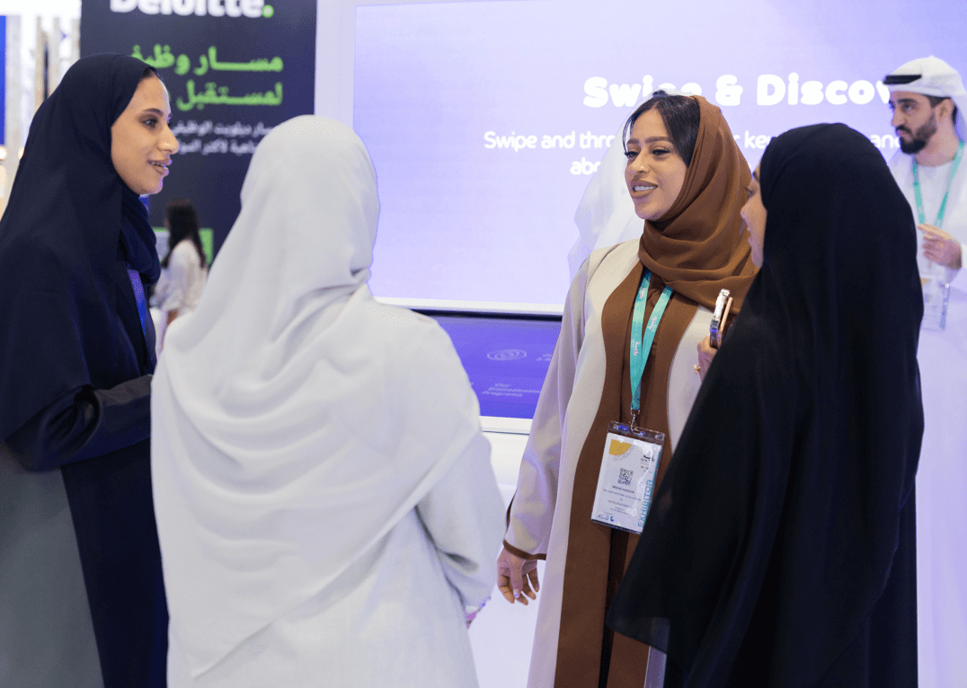 Exhibitor helping visitor to navigate a stall at ruyaa career